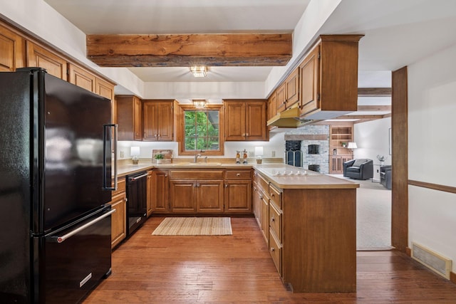 4378 Browndale Ave, Edina, MN 55424 - kitchen featuring black appliances, a peninsula, a sink, beam ceiling, and light countertops