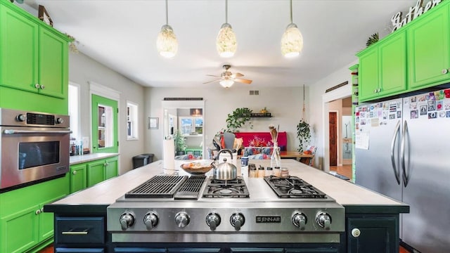 19334 105th Ave, Hayland Twp, MN 56353 - kitchen with appliances with stainless steel finishes, light countertops, a kitchen island, ceiling fan, and green cabinetry