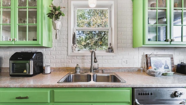 19334 105th Ave, Hayland Twp, MN 56353 - kitchen featuring green cabinetry, dishwasher, and tasteful backsplash