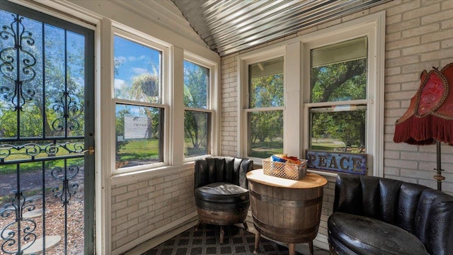 19334 105th Ave, Hayland Twp, MN 56353 - sunroom featuring brick wall, healthy amount of natural light, and lofted ceiling