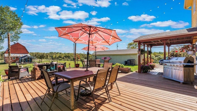 19334 105th Ave, Hayland Twp, MN 56353 - wooden terrace featuring outdoor dining space, an outbuilding, area for grilling, and a gazebo