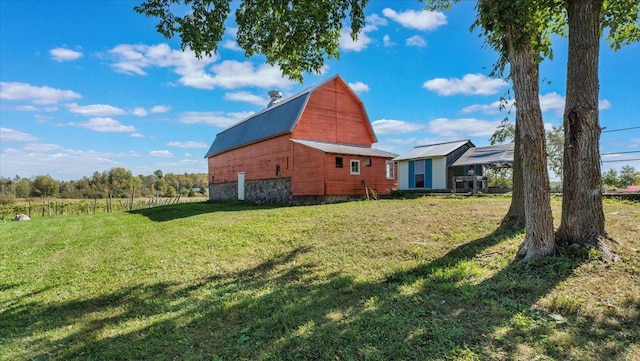 19334 105th Ave, Hayland Twp, MN 56353 - view of home's exterior with a barn, a gambrel roof, an outbuilding, a lawn, and a metal roof