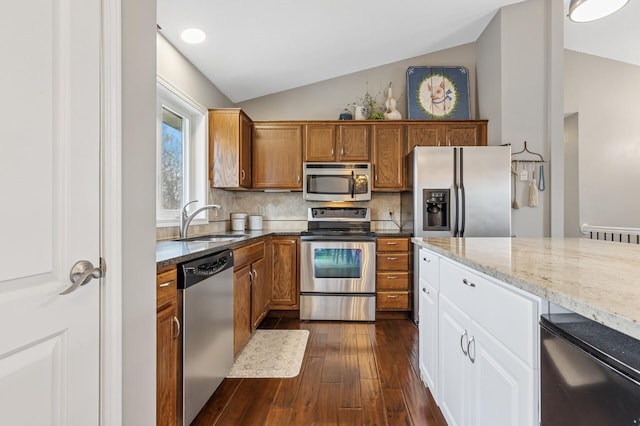 3664 Canary Way, Eagan, MN 55123 - kitchen featuring stainless steel appliances, a sink, vaulted ceiling, dark wood-type flooring, and light stone counters