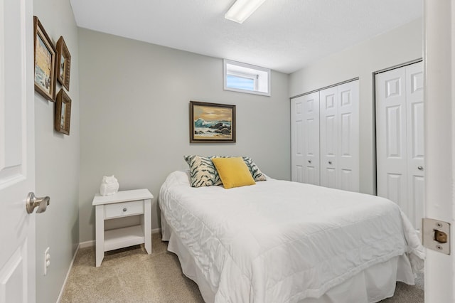 3664 Canary Way, Eagan, MN 55123 - bedroom with light carpet, two closets, baseboards, and a textured ceiling