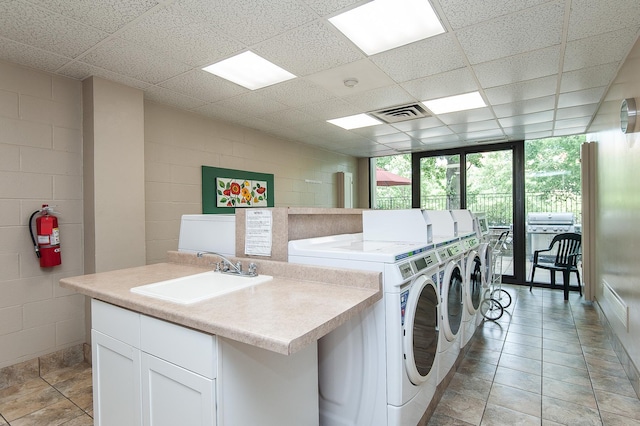 207 5th Ave SW Unit 208, Rochester, MN 55902 - community laundry room featuring washer and clothes dryer and concrete block wall