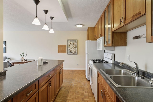 1912 Dupont Ave S Unit 302, Minneapolis, MN 55403 - kitchen featuring a sink, dark countertops, brown cabinetry, decorative light fixtures, and white appliances