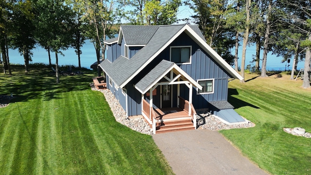 2051 Pine Knoll Rd, Knife Lake Twp, MN 55051 - view of front of home featuring roof with shingles, board and batten siding, and a front lawn