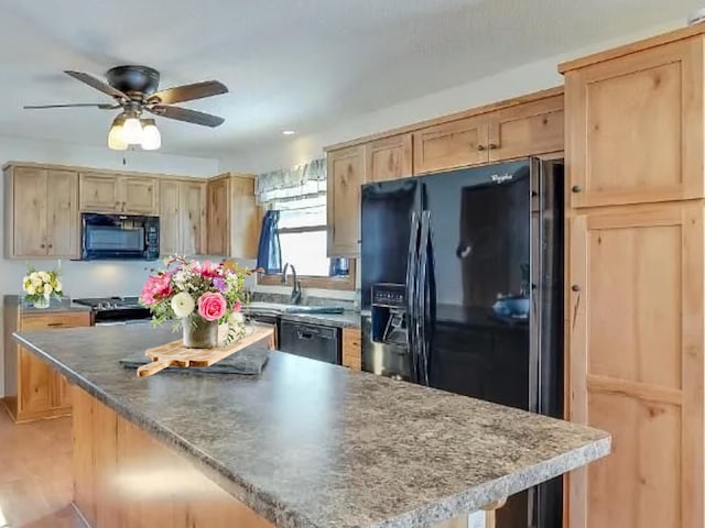 2051 Pine Knoll Rd, Knife Lake Twp, MN 55051 - kitchen with black appliances, a ceiling fan, a sink, light brown cabinets, and a center island