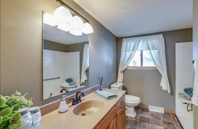 2051 Pine Knoll Rd, Knife Lake Twp, MN 55051 - full bathroom with vanity, toilet, a textured wall, baseboards, and a textured ceiling