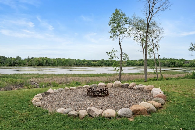 7410 313th Ave NE, North Branch Twp, MN 55056 - view of green lawn featuring an outdoor fire pit and a water view