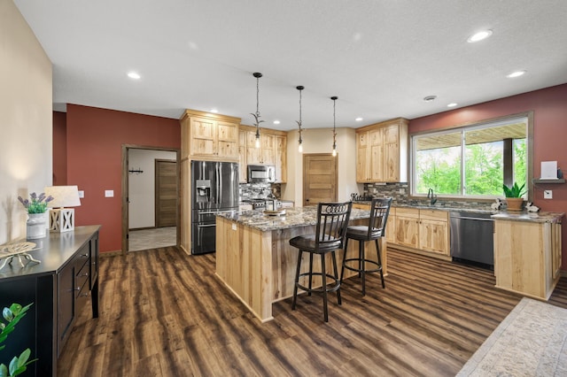 7410 313th Ave NE, North Branch Twp, MN 55056 - kitchen with appliances with stainless steel finishes, light brown cabinets, dark wood-style floors, recessed lighting, and a kitchen island with sink