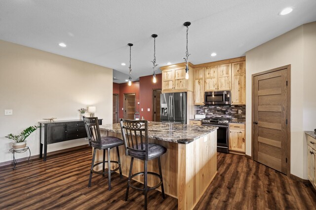 7410 313th Ave NE, North Branch Twp, MN 55056 - kitchen featuring appliances with stainless steel finishes, dark wood-style flooring, a kitchen breakfast bar, light brown cabinetry, and tasteful backsplash