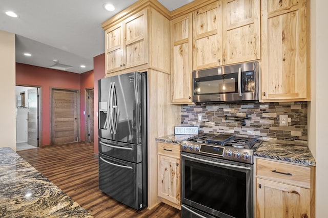 7410 313th Ave NE, North Branch Twp, MN 55056 - kitchen with light brown cabinetry, appliances with stainless steel finishes, tasteful backsplash, dark wood-style floors, and dark stone counters