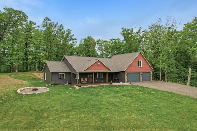 7410 313th Ave NE, North Branch Twp, MN 55056 - view of front of property with driveway, an outdoor fire pit, a porch, a garage, and a front yard
