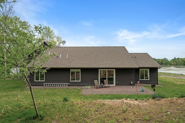 7410 313th Ave NE, North Branch Twp, MN 55056 - back of property with roof with shingles, a patio, and a yard