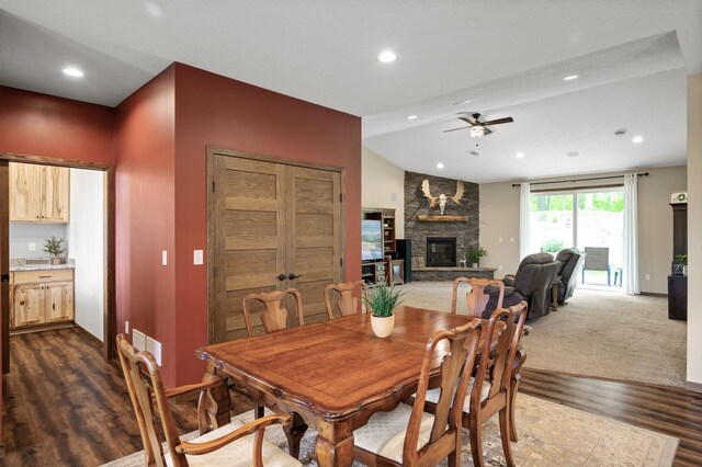 7410 313th Ave NE, North Branch Twp, MN 55056 - dining room featuring ceiling fan, a stone fireplace, dark wood-style floors, vaulted ceiling, and recessed lighting