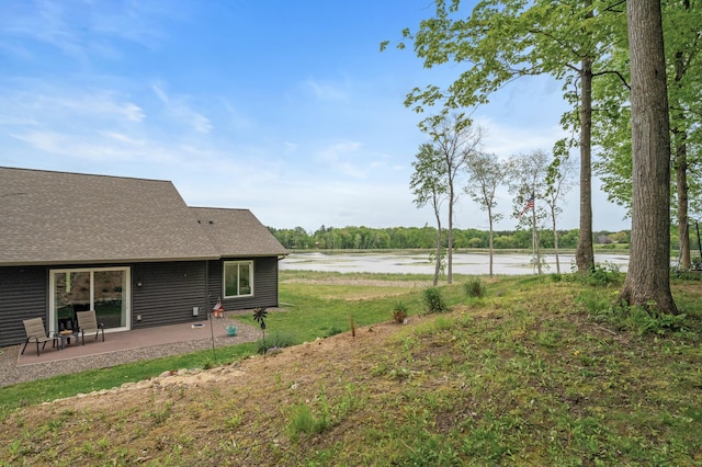 7410 313th Ave NE, North Branch Twp, MN 55056 - view of grassy yard with a patio area and a water view