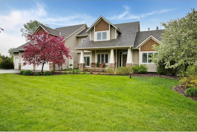 5177 Muir Ave N, Baytown Twp, MN 55082 - craftsman inspired home with covered porch, roof with shingles, a front yard, driveway, and stone siding