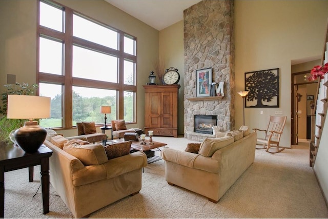 5177 Muir Ave N, Baytown Twp, MN 55082 - living room with a towering ceiling, a fireplace, light colored carpet, and baseboards