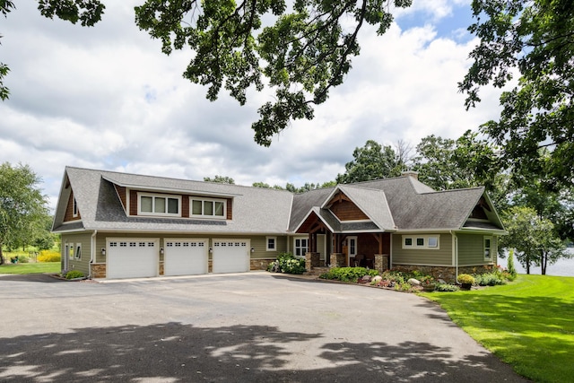 19551 State Highway 18, Brainerd, MN 56401 - craftsman-style house with driveway, stone siding, a front yard, and a garage