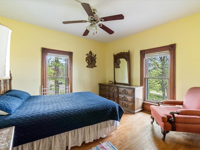 114 Washburn Ave W, Backus, MN 56435 - bedroom with light wood-style floors, multiple windows, and ceiling fan