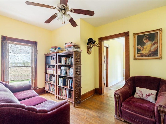 114 Washburn Ave W, Backus, MN 56435 - sitting room featuring wood finished floors, a ceiling fan, and baseboards