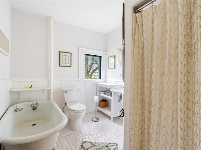114 Washburn Ave W, Backus, MN 56435 - full bath featuring wainscoting, a freestanding bath, and toilet