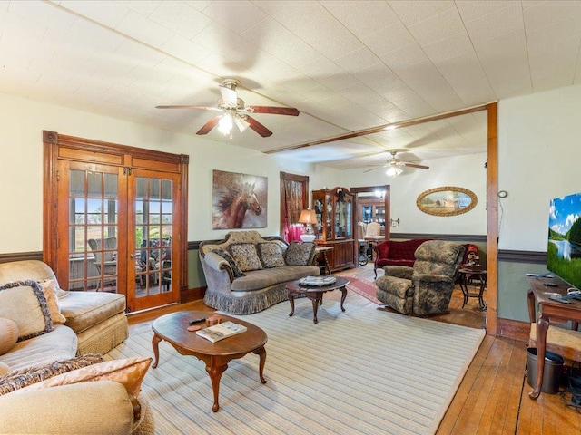 114 Washburn Ave W, Backus, MN 56435 - living room with a ceiling fan, french doors, hardwood / wood-style floors, and baseboards