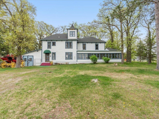 114 Washburn Ave W, Backus, MN 56435 - back of property with a sunroom, a yard, and a chimney