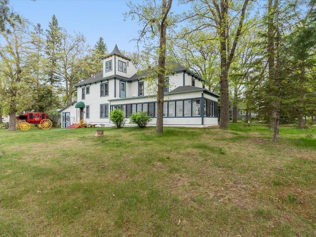 114 Washburn Ave W, Backus, MN 56435 - rear view of property with a sunroom and a yard