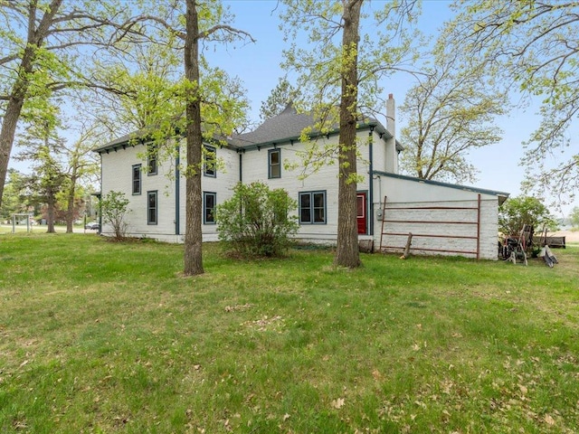 114 Washburn Ave W, Backus, MN 56435 - rear view of property with a chimney and a yard