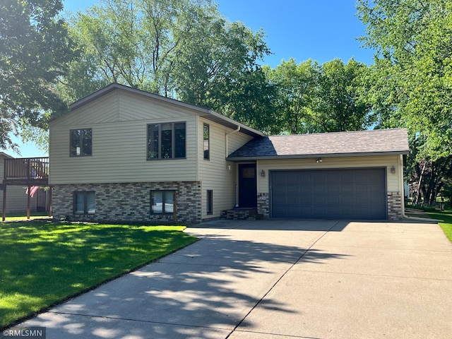 204 10th St N, Sartell, MN 56377 - tri-level home with a garage, driveway, a front lawn, and brick siding