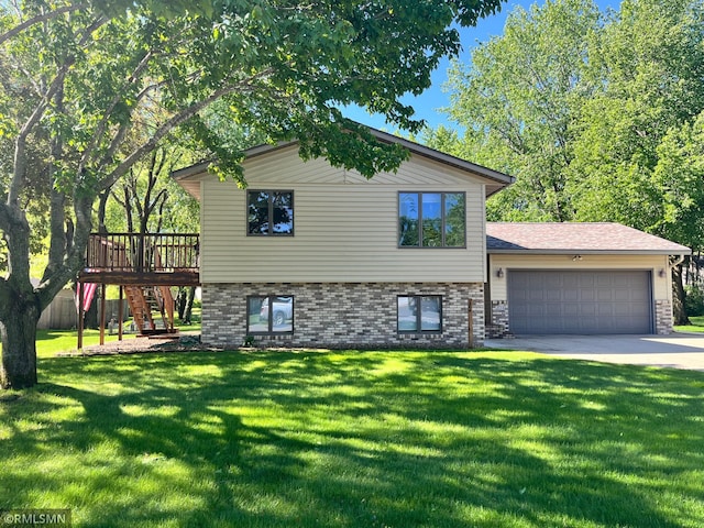 204 10th St N, Sartell, MN 56377 - split level home featuring stairway, an attached garage, a front lawn, brick siding, and driveway