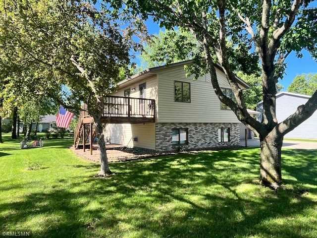 204 10th St N, Sartell, MN 56377 - view of home's exterior with a yard, a deck, and brick siding