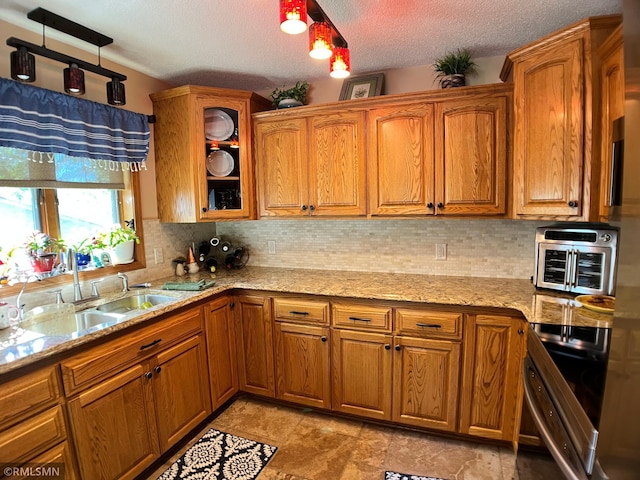 204 10th St N, Sartell, MN 56377 - kitchen featuring electric range, decorative backsplash, brown cabinets, light stone countertops, and glass insert cabinets