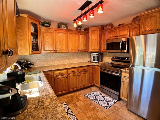 204 10th St N, Sartell, MN 56377 - kitchen with stainless steel appliances, backsplash, glass insert cabinets, brown cabinets, and a textured ceiling
