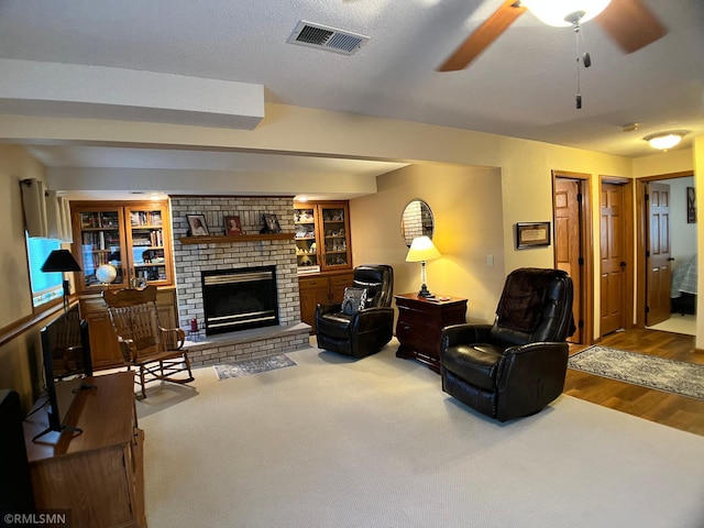 204 10th St N, Sartell, MN 56377 - living room featuring a brick fireplace, wood finished floors, and ceiling fan