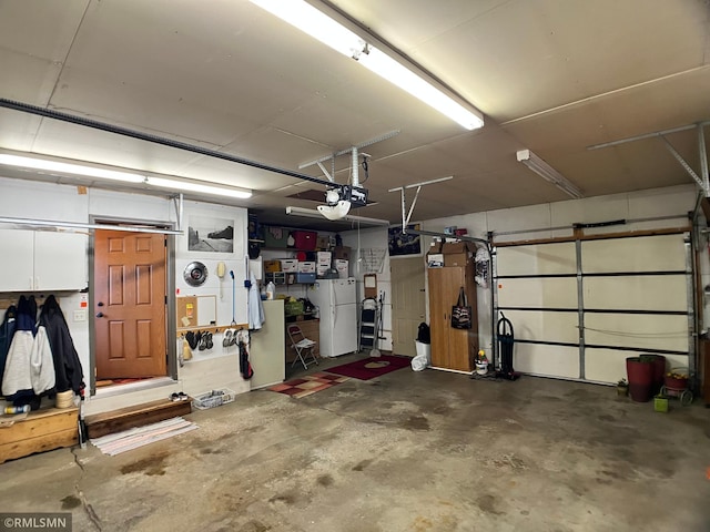 204 10th St N, Sartell, MN 56377 - garage featuring freestanding refrigerator and a garage door opener