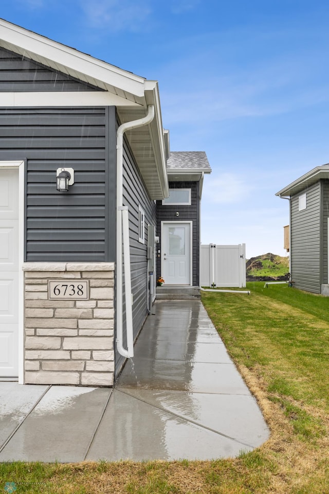 6738 Joseph St, Horace, ND 58047 - doorway to property with a lawn