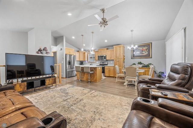 6738 Joseph St, Horace, ND 58047 - living room featuring a chandelier, a ceiling fan, light wood-style flooring, high vaulted ceiling, and recessed lighting