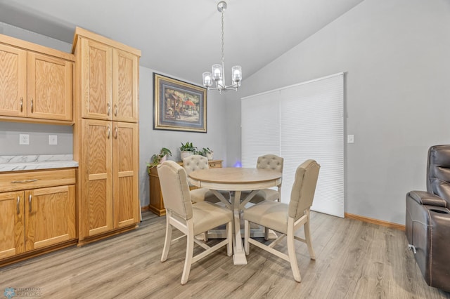 6738 Joseph St, Horace, ND 58047 - dining area featuring lofted ceiling, a chandelier, light wood finished floors, and baseboards