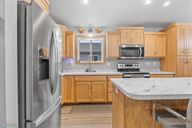 6738 Joseph St, Horace, ND 58047 - kitchen with appliances with stainless steel finishes, a sink, light countertops, light wood finished floors, and recessed lighting