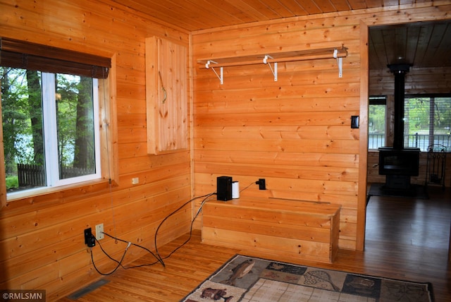 48080 218th Pl, Mcgregor, MN 55760 - laundry area with a wood stove, wooden walls, wood finished floors, and wooden ceiling