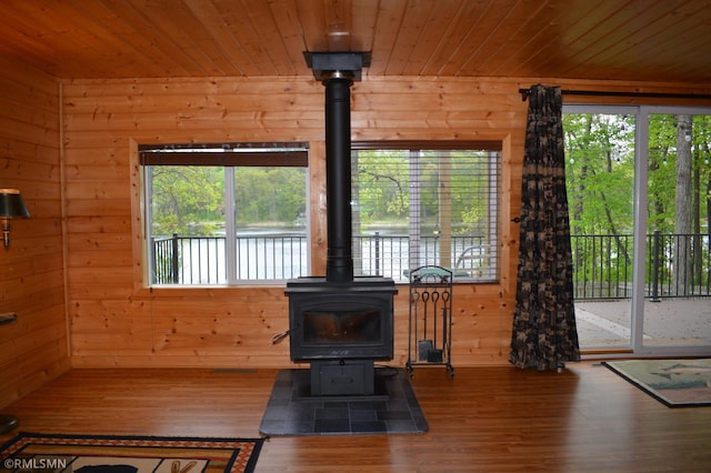 48080 218th Pl, Mcgregor, MN 55760 - living room with a wood stove, wood walls, healthy amount of natural light, wooden ceiling, and wood finished floors