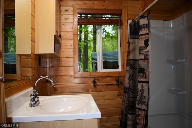 48080 218th Pl, Mcgregor, MN 55760 - full bathroom featuring wooden walls, a shower with shower curtain, and vanity