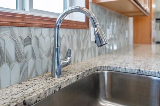 1004 7th Ave NW, Kasson, MN 55944 - kitchen view of a sink, tasteful backsplash, and light stone counters
