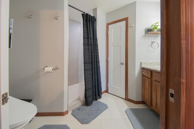 1004 7th Ave NW, Kasson, MN 55944 - full bathroom featuring a tile shower, vanity, baseboards, and tile patterned floors