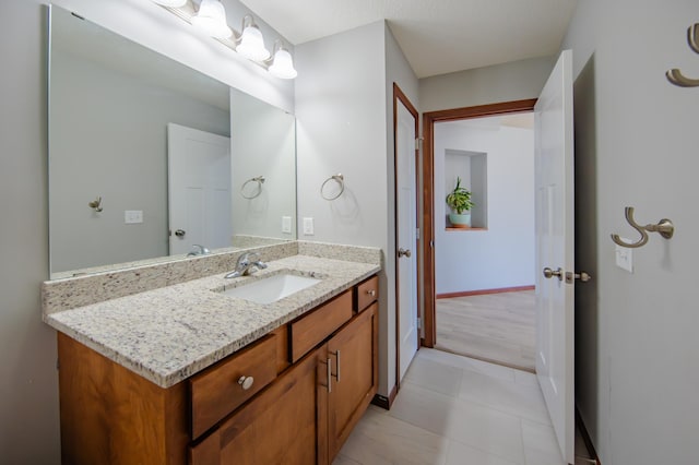 1004 7th Ave NW, Kasson, MN 55944 - bathroom featuring vanity, baseboards, and tile patterned floors