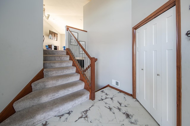 1004 7th Ave NW, Kasson, MN 55944 - staircase featuring marble finish flooring, baseboards, and vaulted ceiling