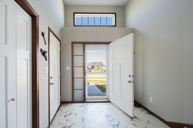 1004 7th Ave NW, Kasson, MN 55944 - entryway with light marble finish floors, baseboards, and a high ceiling